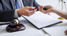 Hands exchanging documents and pen