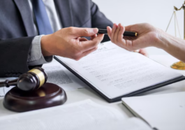 Hands exchanging documents and pen